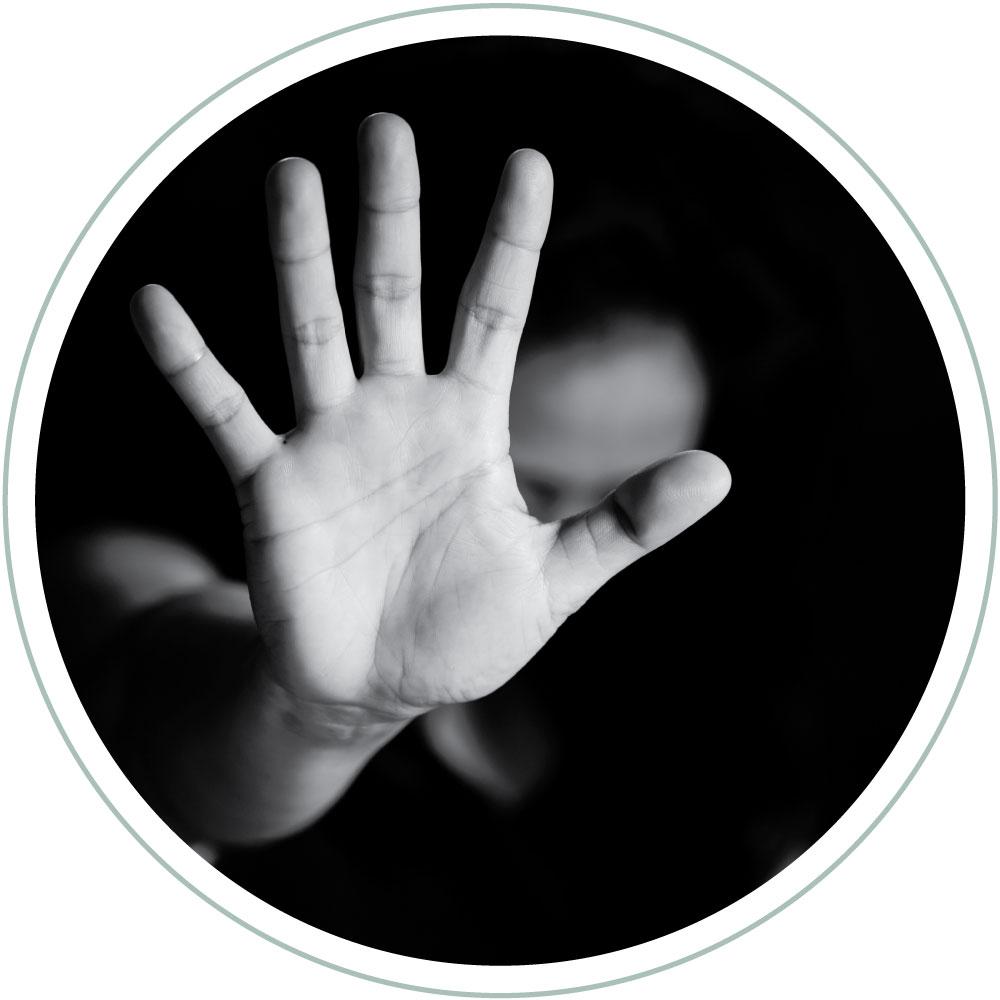a womans hand stretched out and facing the camera. A gesture that indicates stop, enough. Black and white